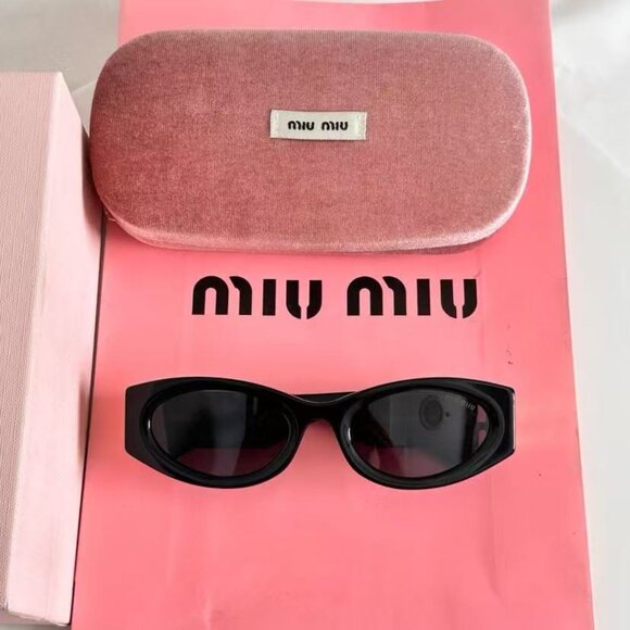 Miu Miu black sunglasses featuring elegant gold accents main image 4